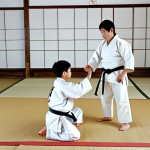 **Judo Greeting:** "A young, fully clothed martial artist in a clean, white judogi, performing a standing bow (Ritsu-rei) to their instructor in a traditional dojo setting. The dojo has tatami mats and simple decor.  Perfect anatomy, correct proportions, natural pose. Safe for work, appropriate content, family-friendly, professional photography, high quality."